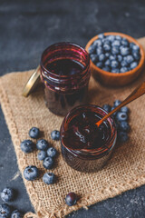 Delicious organic blueberry jam on dark background