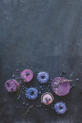 Cake, cupcake and donuts top view, background