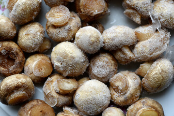 Frozen mushrooms on a cup. Frozen vegetables.