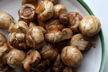 Defrosted champignons on a cup. Thawed vegetables.