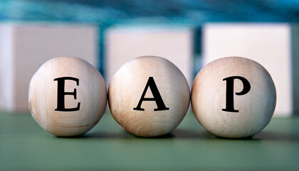 EAP - acronym on wooden balls on the background of wooden large cubes