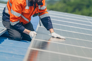 Worker Technicians are working to construct solar panels system on roof. Installing solar photovoltaic panel system. Men technicians walking on roof structure to check photovoltaic solar modules.