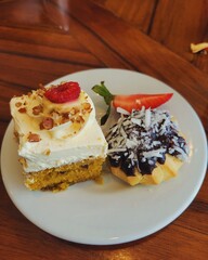 Two delicious desserts on plate, gourmet, bakery, pastry, dessert platter, fine dining, restaurant, cafe, coffee shop, sweet treat, indulgence, celebration, special occasion, delicious, tres leches
