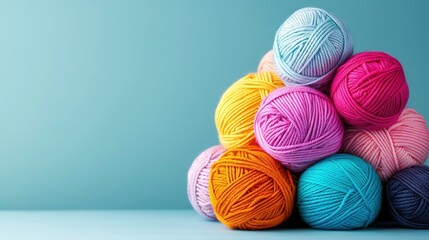   Multicolored yarn balls on blue surface