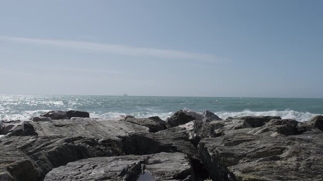 rocks and rough Ligurian sea in Italy Boccadasse. High quality 4k footage