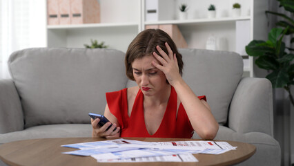 Stressed young woman has financial problems with credit card debt to pay prim from bad personal money and mortgage pay management crisis. Woman worry about financial bankruptcy risk from over spending