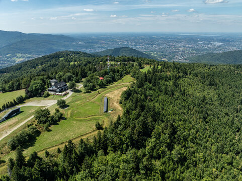 Stunning aerial drone view of summer green forests in the Beskids, Bielsko Biała, Magurka Wilkowicka. Shelter on Magurka Wilkowicka. Beskid summer mountains panorama.