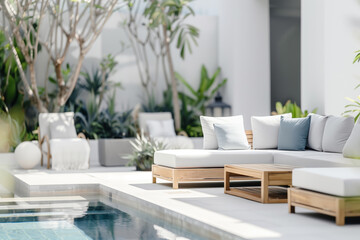 Outdoor pool area with modern furniture, surrounded by garden with plants and trees