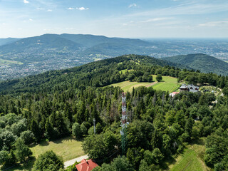 Stunning aerial drone view of summer green forests in the Beskids, Bielsko Biała, Magurka Wilkowicka. Shelter on Magurka Wilkowicka. Beskid summer mountains panorama.