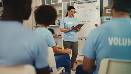 Female volunteer discussing future charity projects with colleagues at meeting