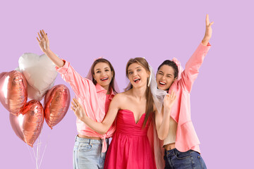 Young woman with her bridesmaids and balloons on lilac background. Hen Party