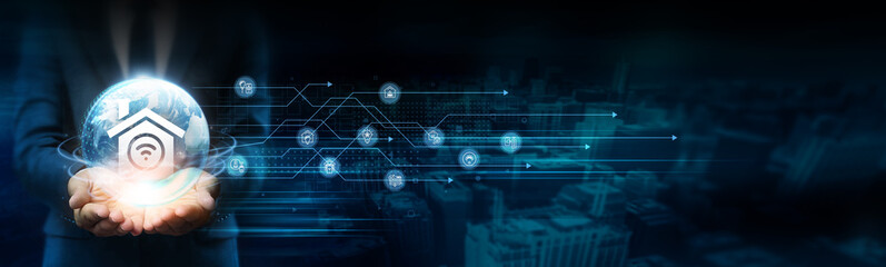 Businessman holds global smart home technology with network connected to devices and appliances. Sustainable development technology drives innovation and efficiency in modern homes.