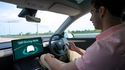 Self driving car or autonomous vehicle travel on speed highway with driverless system and autopilot mode allowing man driver relax and focus on smartphone without compromising safety. Perpetual