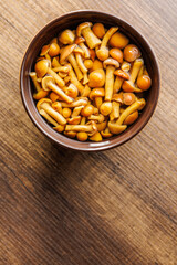Pickled nameko mushrooms.Traditional japanese mushrooms in bowl on wooden table. Top view.
