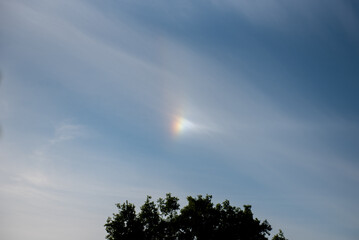 atmospheric optical phenomena. Iridescent clouds with blue sky