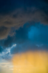 Obraz premium Yellow light under thunder clouds