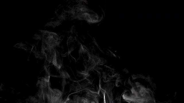 Real smoke from incense on black background, smoke overlay in slow motion. Close up.