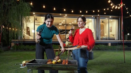 Family gather celebrate holiday. Focus Mother and grandmother drink wine and grill food for family...