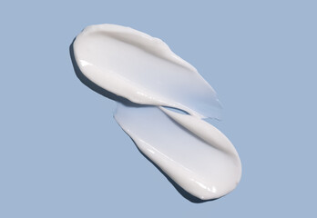 Cosmetic smear of cream texture on a blue background. Moisturizing the skin.