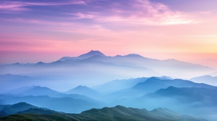 Obraz premium The mountains are covered in a blue mist and the sky is a beautiful shade of pink. The scene is serene and peaceful, with the mountains towering over the landscape