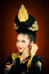 young asian women wearing makeup, wearing batik clothes and Indonesian cultural attributes