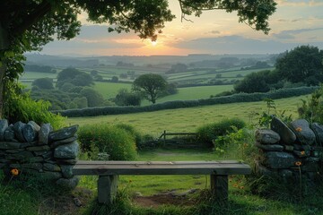 This serene image captures a beautiful sunset over a lush and rolling countryside landscape, featuring a rustic stone bench in the foreground and distant hills in the background.