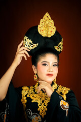 young asian women wearing makeup, wearing batik clothes and Indonesian cultural attributes