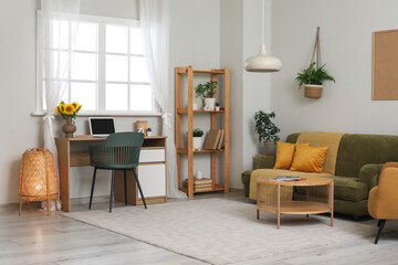 Interior of living room with workplace, sofa and shelf unit
