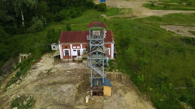 Stunning Aerial Drone Footage of the Top of an Elevator Shaft in the Vast Salina Slanic Prahova Salt Mine, Carpathian Mountains, Romania - A Unique Perspective of an Underground Wonder
