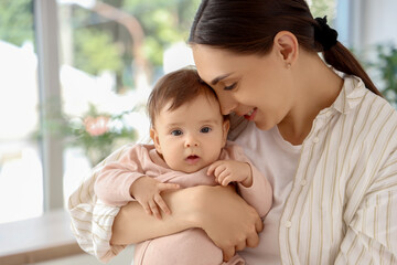Mother with her little baby at home, closeup