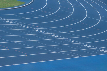 Blue track and field lanes. Running lanes at a track and field athletic stadium. Horizontal sport...