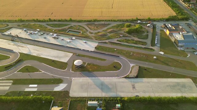 Aerial drone footage of a racing circuit and defensive driving course facility. High angle shot of asphalt and offroad sections of a drifting and racing driving training facility. stunt driver concept