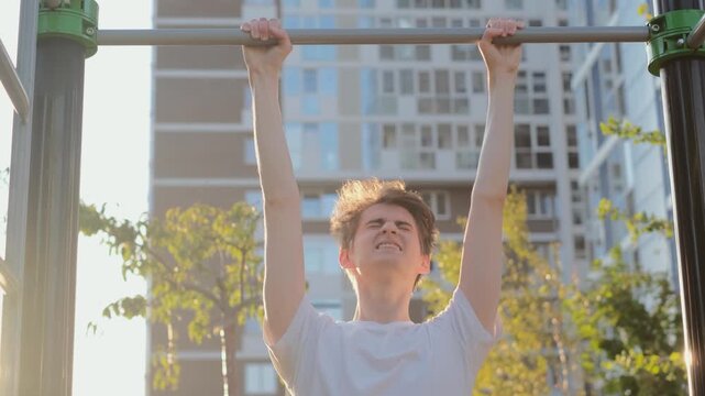 A young weak guy cannot do pull-ups on the horizontal bar