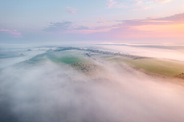 Dense morning fog enveloped the farmland. Aerial photography. Beauty of earth.