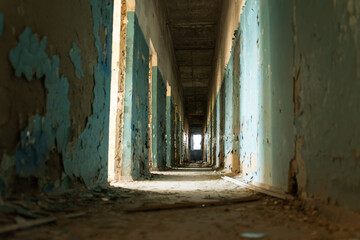 Abandoned Hospital Corridor With Peeling Paint and Dusty Floors in Autumn Light