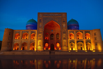 Ancient Mir-i-Arab madrasah in beautiful night illumination.