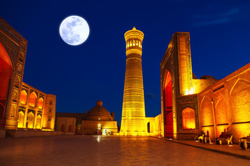 The architectural ensemble of Poi Kalyan - minaret, madrasah and mosque in beautiful illumination.