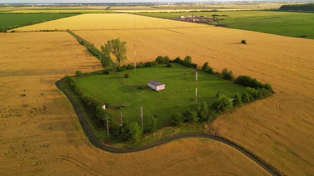 Drone footage of ILS system marker beacon near an international airport. High angle shot of rural field with 75Mhz antenna for landing approach guidance and assistance of airplanes. VFR Radio
