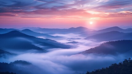 Fototapeta premium Fog covered valley at sunrise with mountains in the background