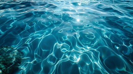 Obraz premium Crystal clear blue waters with gentle ripples under bright sunlight