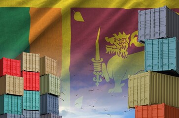 Sri Lanka flag and big stack of shipping cargo containers in docks with sky background close up