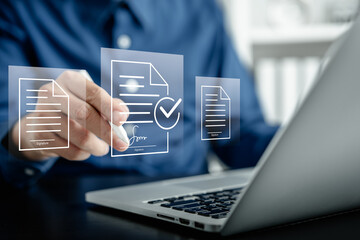 Businessmen using a stylus pen to sign one document on a virtual notebook screen, E-signing, electronic signature, approved document management, and paperless office concept.