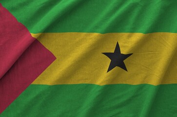 Sao Tome and Principe flag depicted on folded wavy fabric of old cloth close up