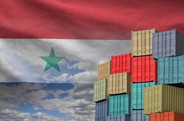 Syria flag and big stack of shipping cargo containers in docks with sky background close up