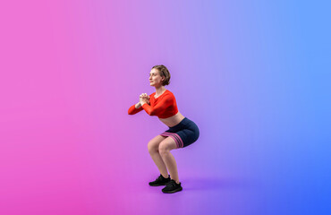 Full body length gaiety shot athletic and sporty young woman with fitness elastic resistance band...