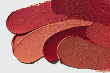 Lipstick burgundy purple pink red orange beige palette set smudge background texture isolated on...