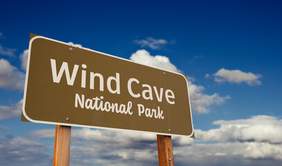 Wind Cave National Park (South Dakota) Road Sign Against Blue Sky and Clouds.