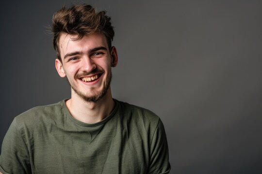 Young handome man smiling over gray background
