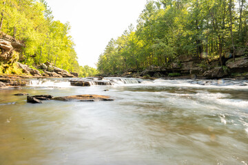 Obraz premium A gorgeous view of water near trees and plants at a local park in Minnesota.