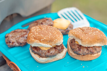 Selective focus background image of burgers grillin summer activitie